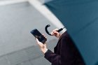 Woman with OANDA Mobile App on her phone