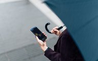Woman with OANDA Mobile App on her phone